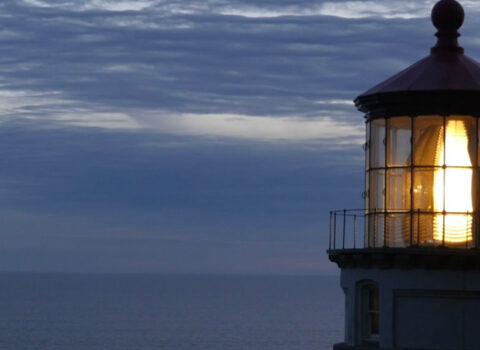 top of a lighthouse while lit at dusk The Game Changers Inc Eric Boles coaching keynoting training